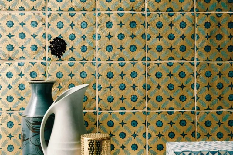 Blue and green floral patterned bathroom tiles with white basin