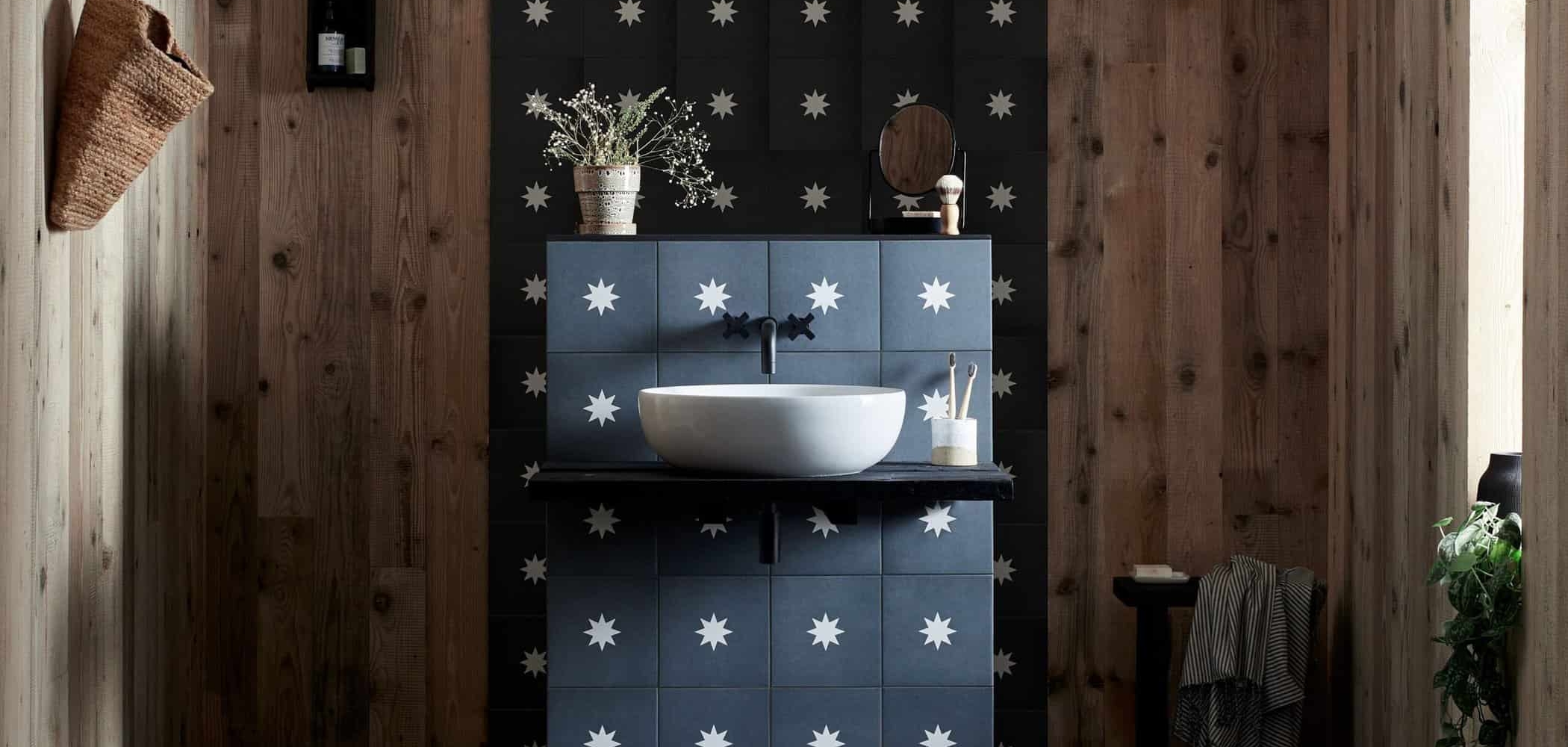 Dark tiled bathroom feature wall with contemporary blue basin