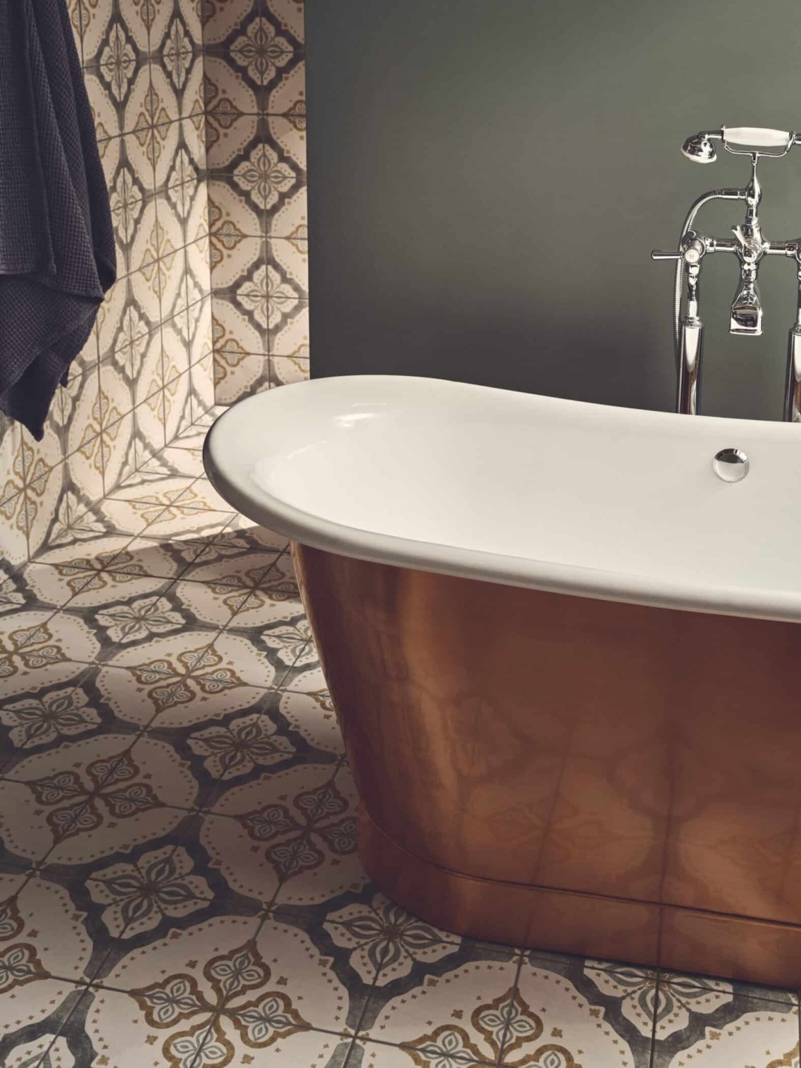 Jaipur Sikkar patterned bathroom tiles beside a white freestanding bath