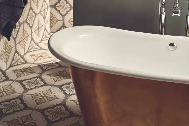 Jaipur Sikkar patterned bathroom tiles beside a white freestanding bath