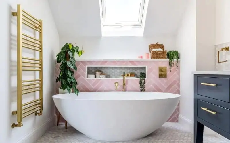 Pink bathroom with skylight, recessed storage niche and indoor greenery