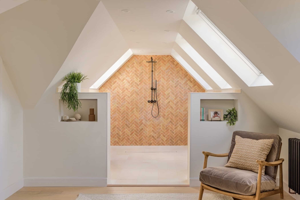 Attic shower with timber herringbone feature wall, black fittings and skylights