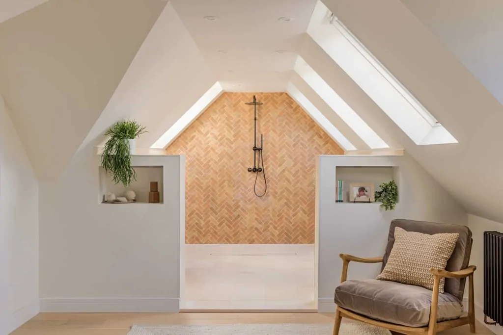 Attic shower with timber herringbone feature wall, black fittings and skylights