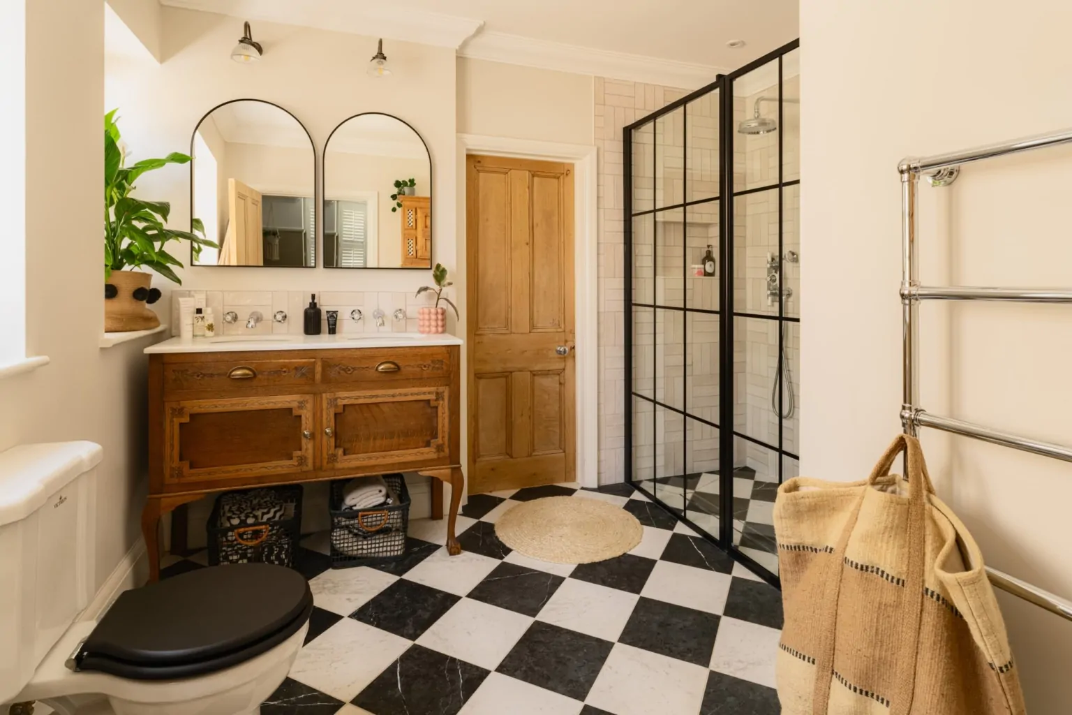 Bespoke bathroom with timber double vanity and black framed shower enclosure