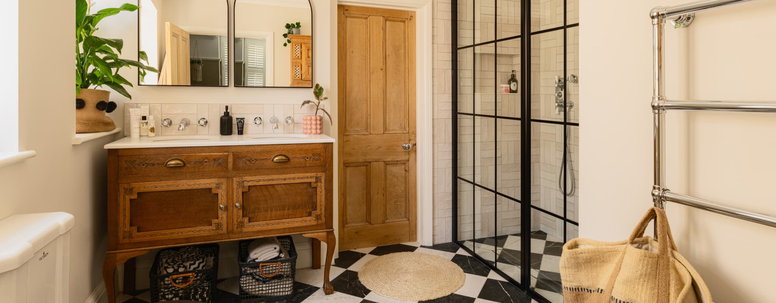 Bespoke bathroom with timber double vanity and black framed shower enclosure