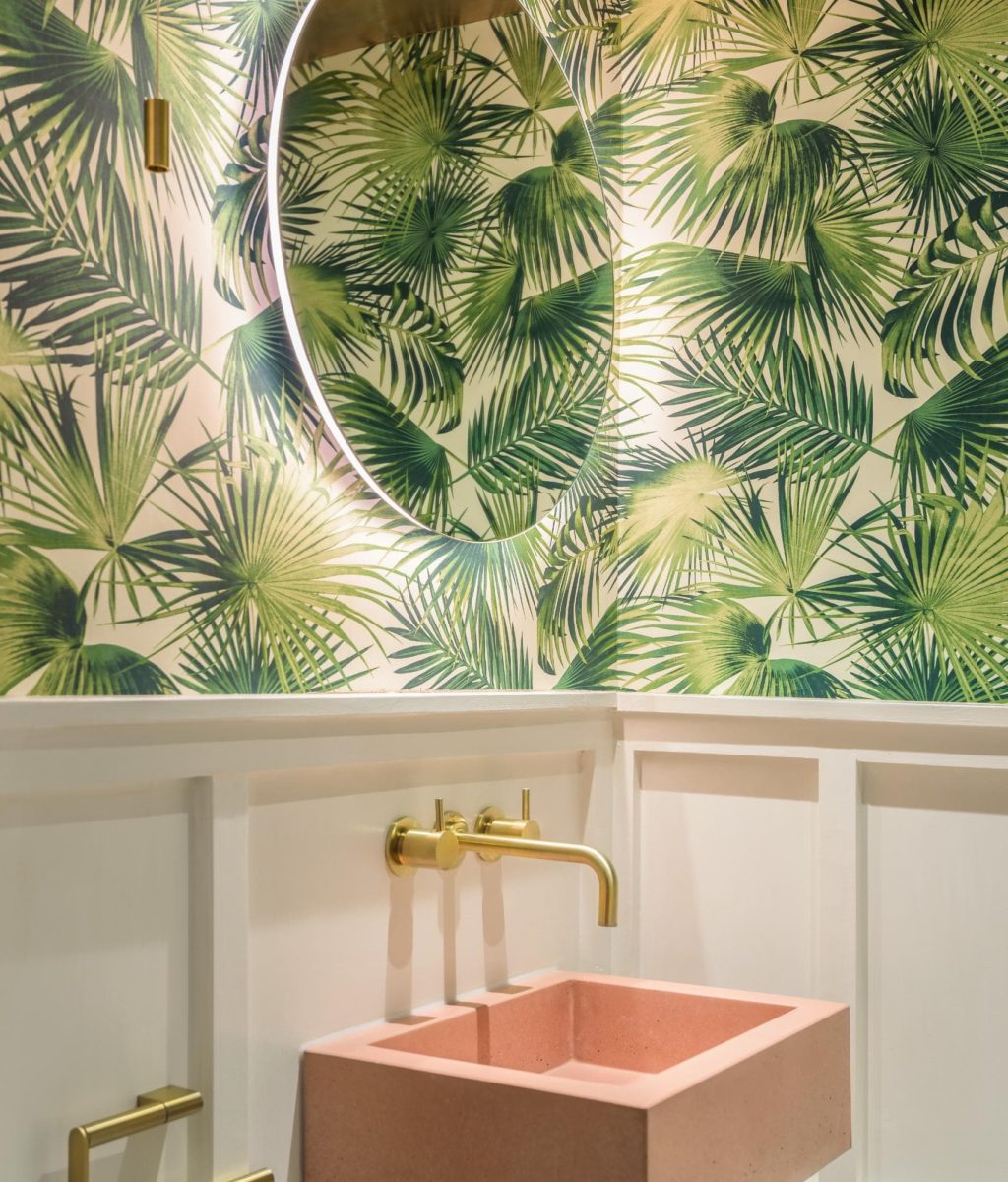 Botanical bathroom with tropical wallpaper and soft neutral finishes