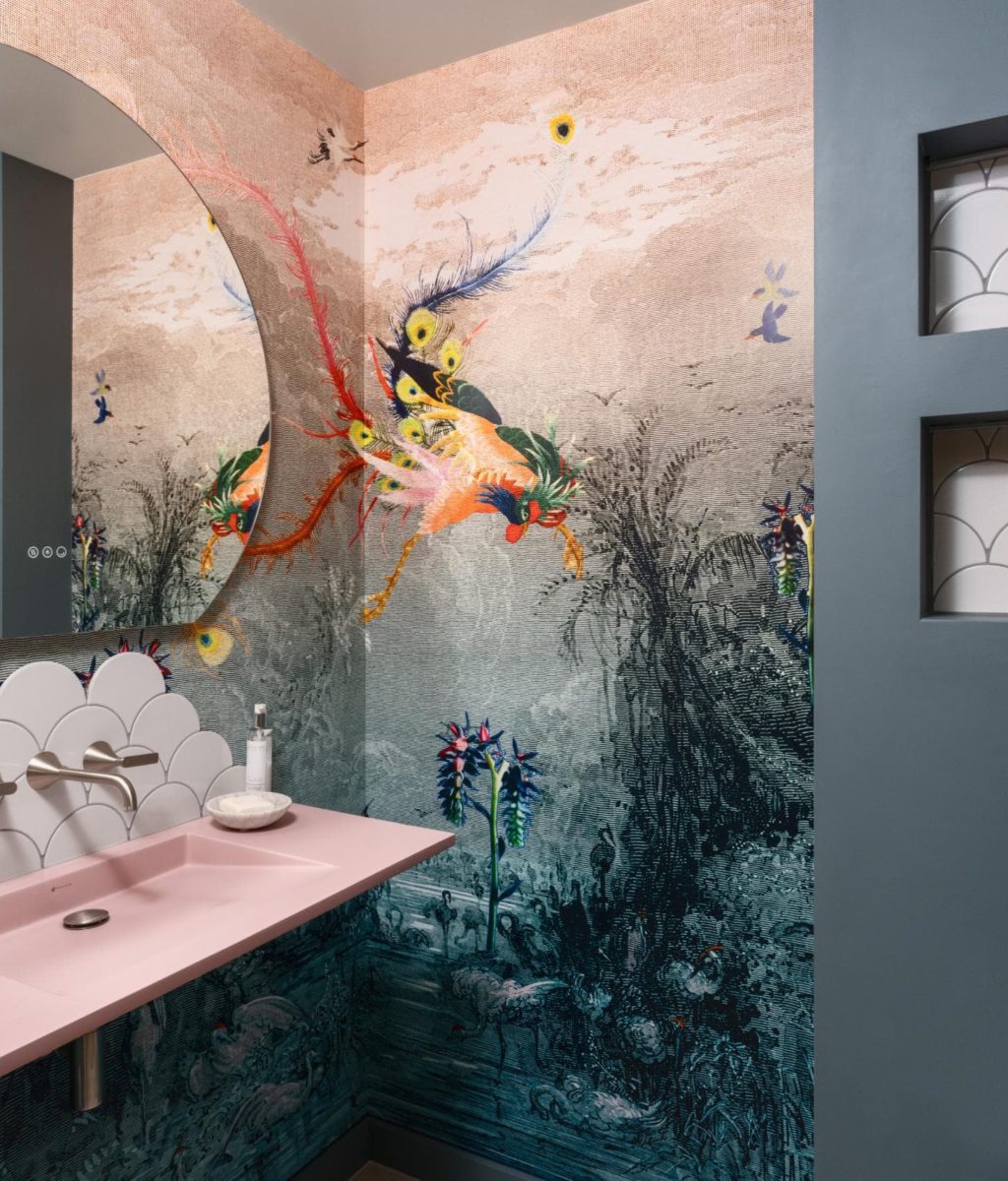 Statement bathroom with artistic mural wall and pink vanity