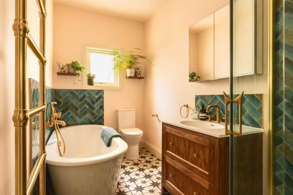 Contemporary neutral bathroom with dark green herringbone tile detailing