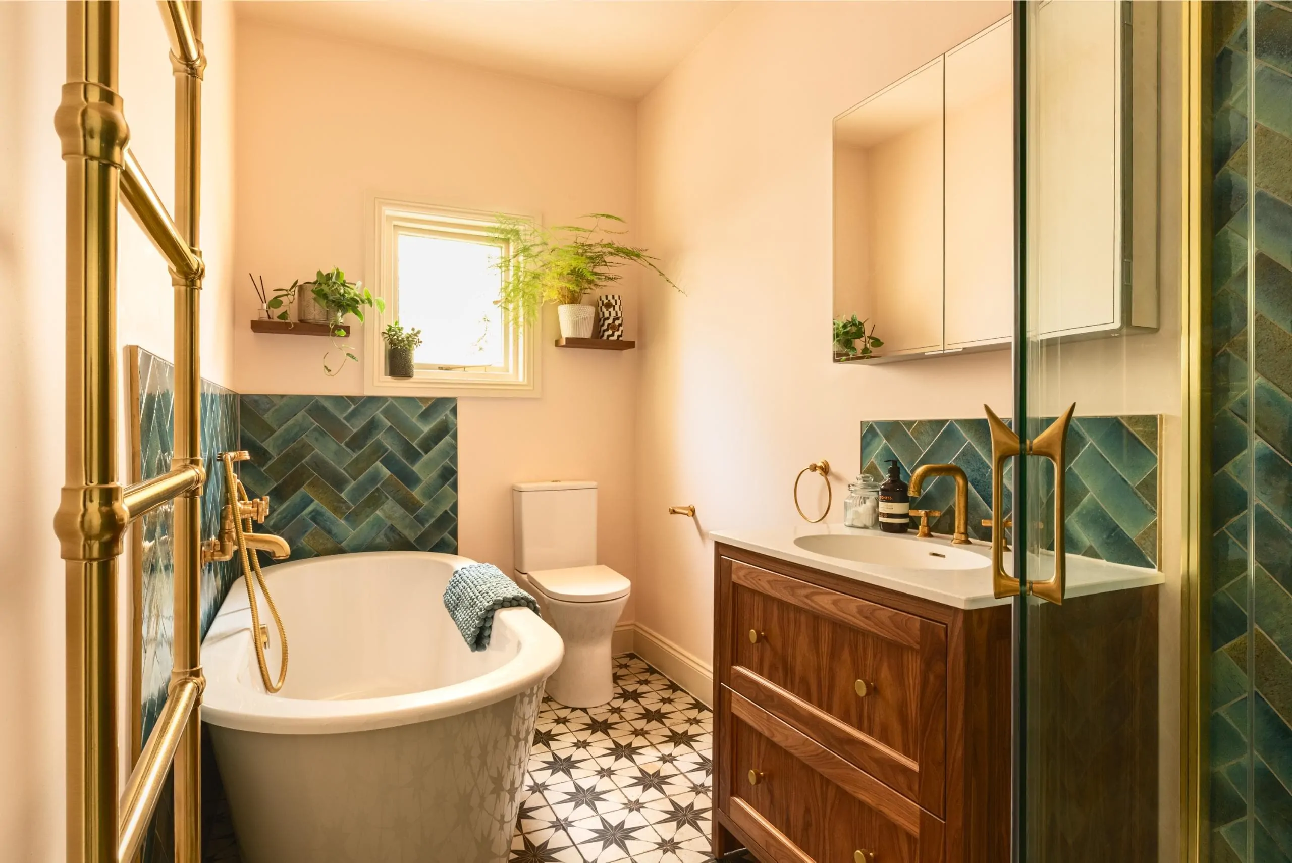 Contemporary neutral bathroom with dark green herringbone tile detailing