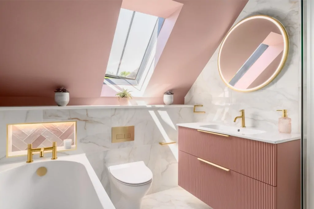 Luxury pink attic bathroom with skylight, vanity and marble effect surfaces