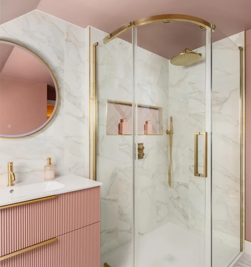 Marble effect bathroom with curved glass shower screen and brass fittings