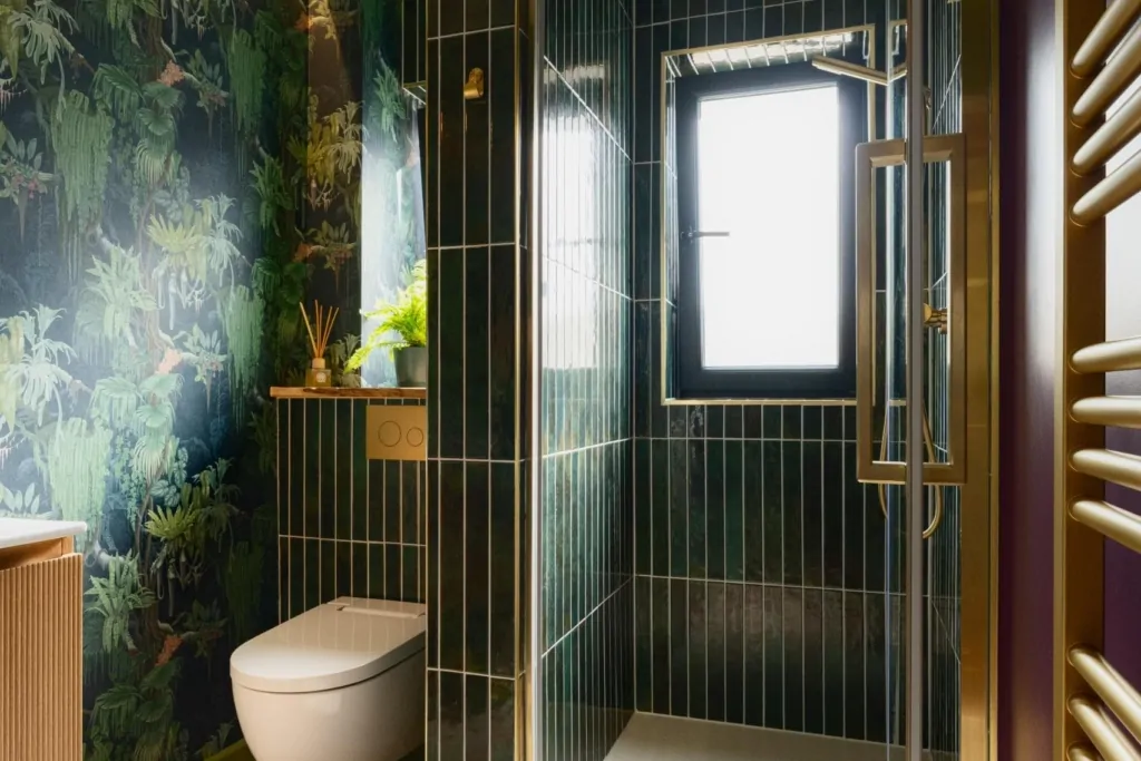 Bespoke dark bathroom design with greenery, vanity and feature wallpaper