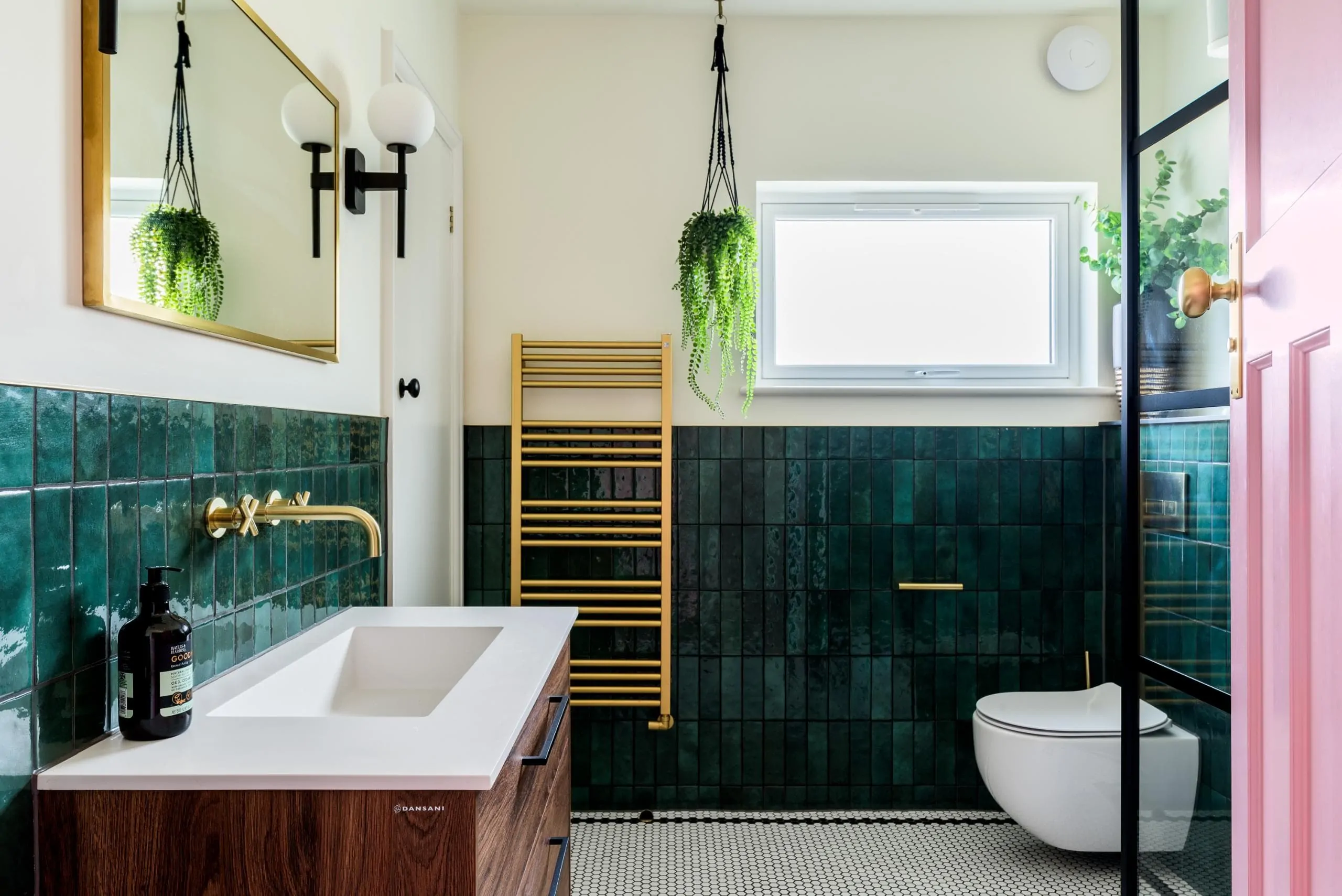 Green tiled bathroom with window, heated towel rail and black wall lighting