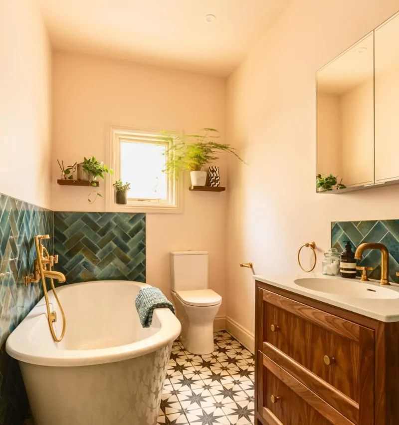 Neutral bathroom with dark green herringbone tile feature wall