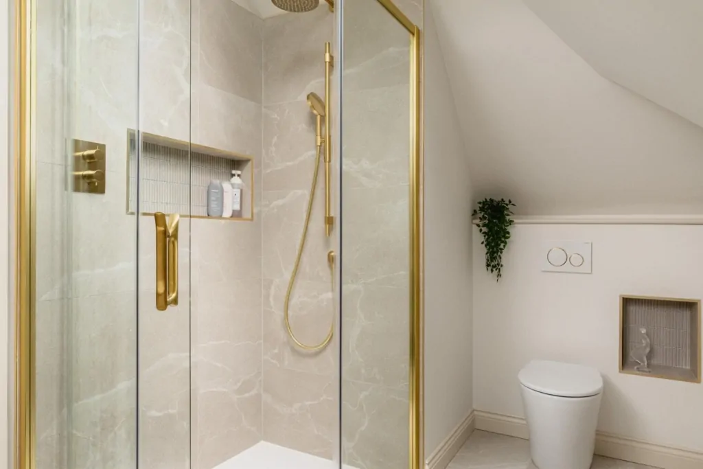 Contemporary walk-in shower with brass fittings and arched bathroom mirror
