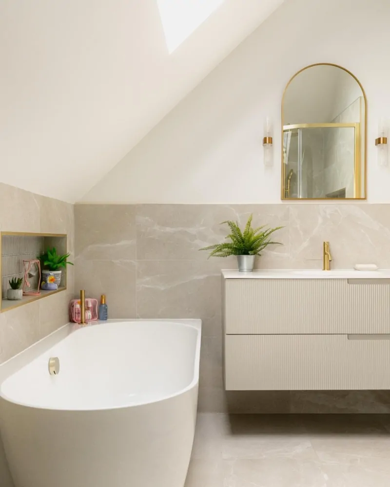 Bespoke neutral bathroom design with shower enclosure and arched mirror