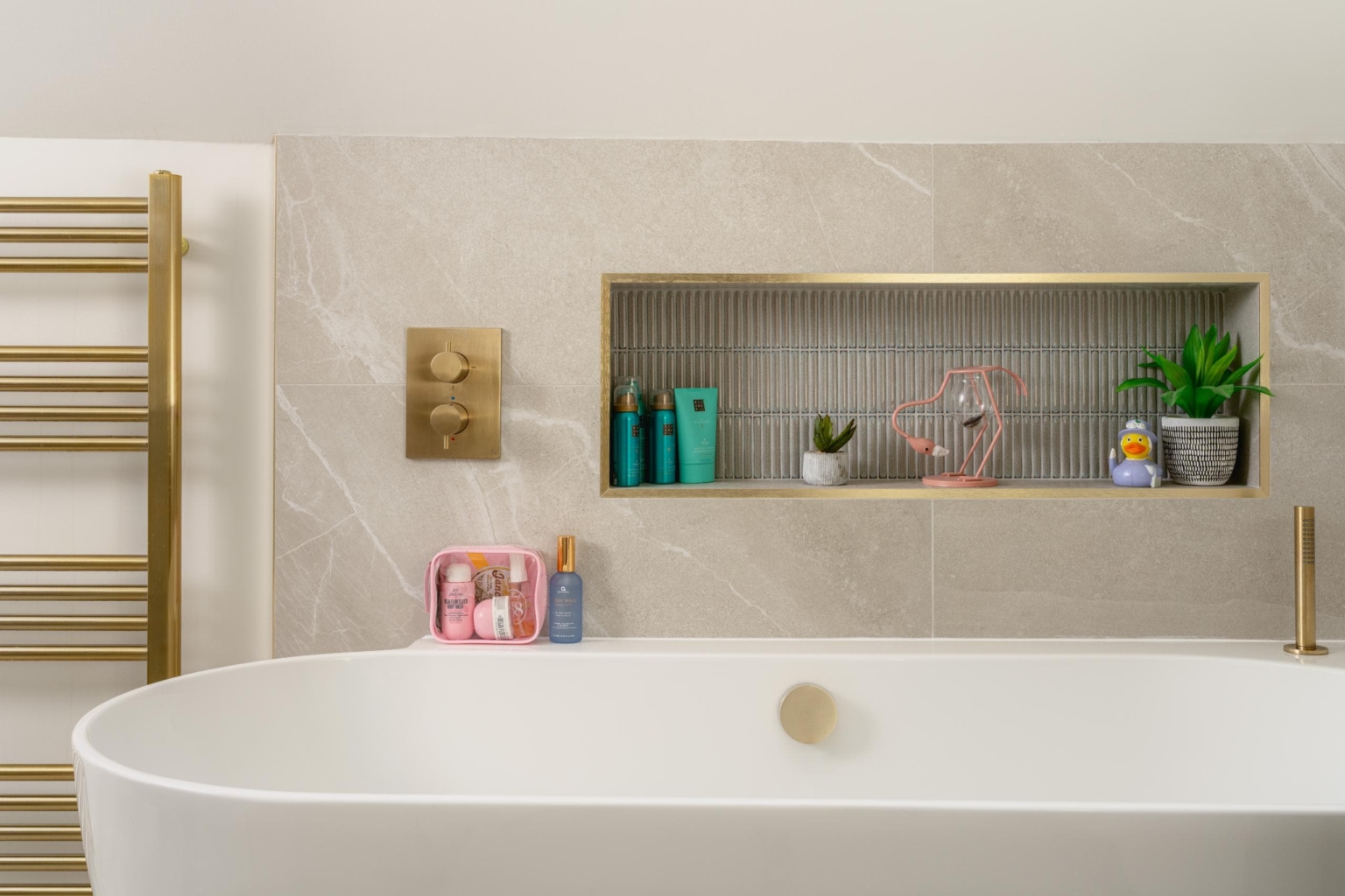 Built-in bathroom niche with neutral tiling and recessed storage