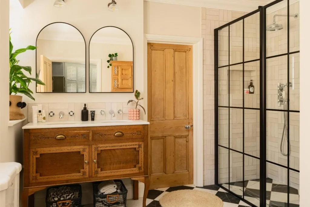 Luxury neutral bathroom with timber vanity and black framed shower enclosure