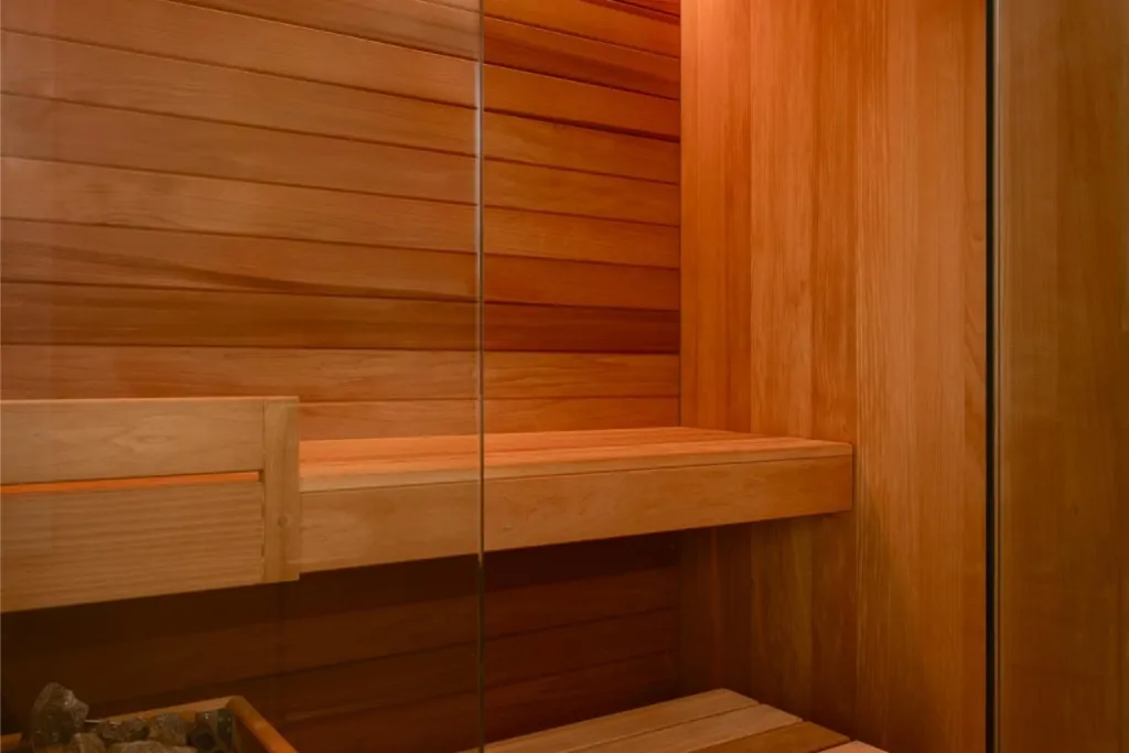 Bespoke timber sauna interior with wooden bench and warm ambient lighting