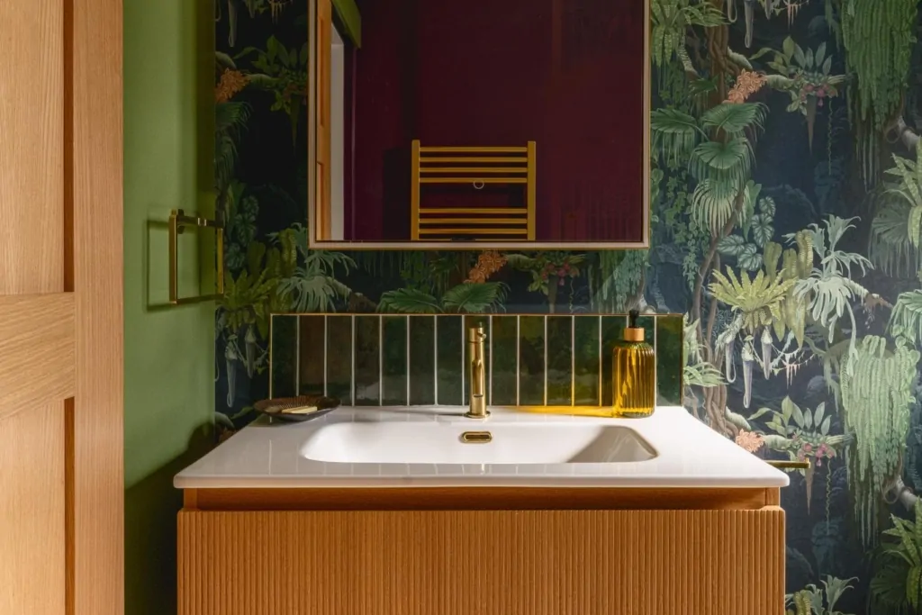 Luxury bathroom with botanical wallpaper, bold colour and greenery