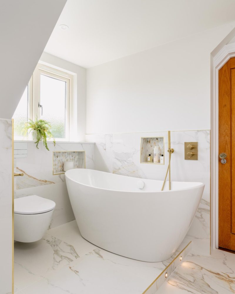 Light neutral bathroom with timber door, window and marble effect finishes