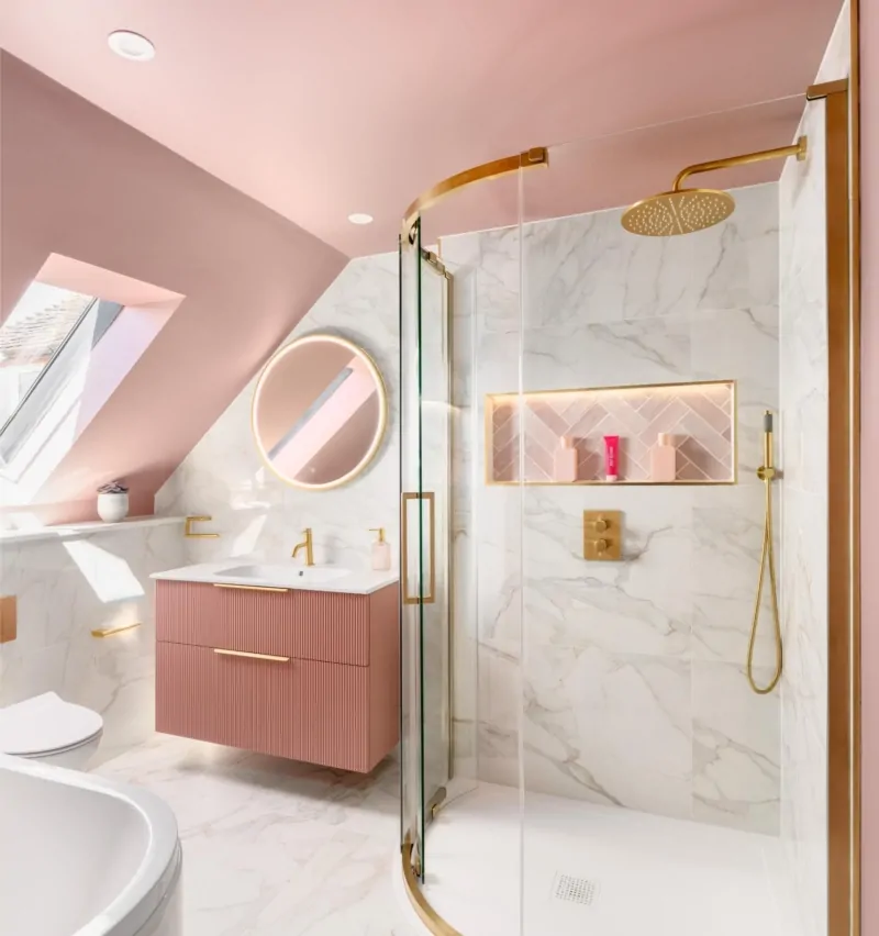 Contemporary attic bathroom with soft pink walls, skylight and round mirror