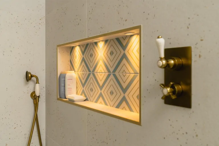 Illuminated shower niche with patterned tiles and built-in bathroom storage