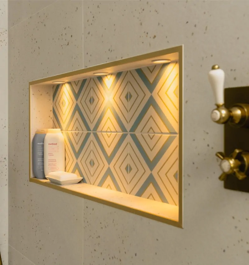 Illuminated shower niche with patterned tiles and built-in bathroom storage