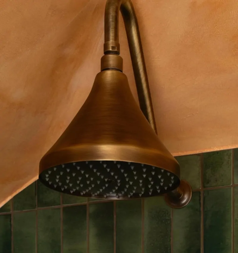 Copper rainfall shower head in a luxury contemporary bathroom