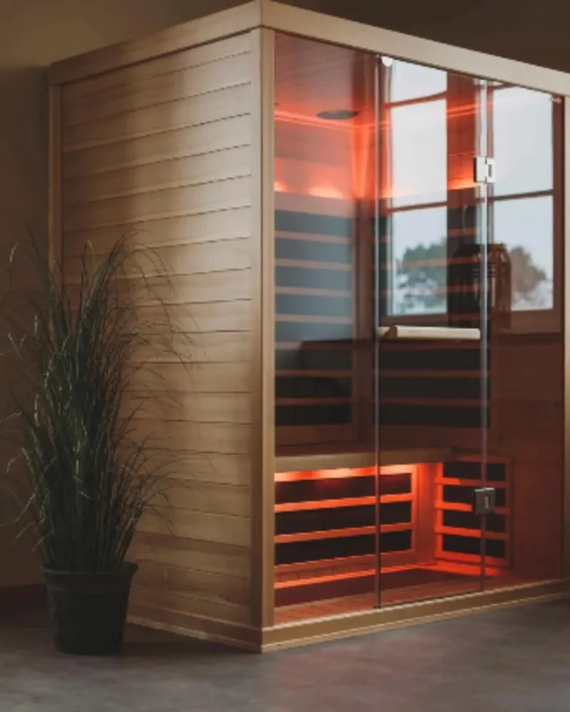 Infrared sauna cabin with timber interior and ambient red lighting