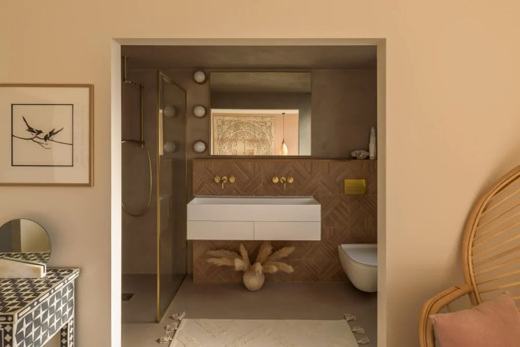 Warm neutral bathroom with bespoke vanity, storage and recessed lighting