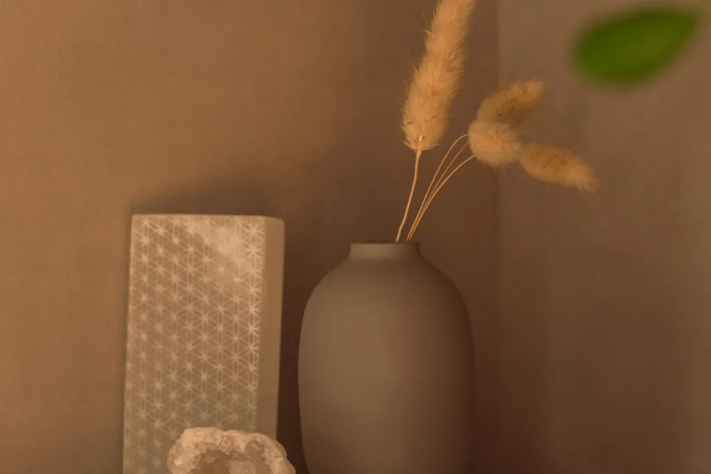 Decorative vase and dried flowers in a warm neutral bathroom interior