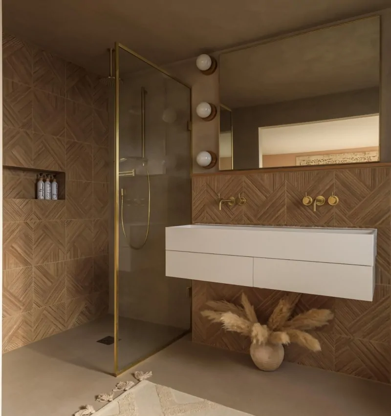 Contemporary tiled shower enclosure in a warm neutral bathroom