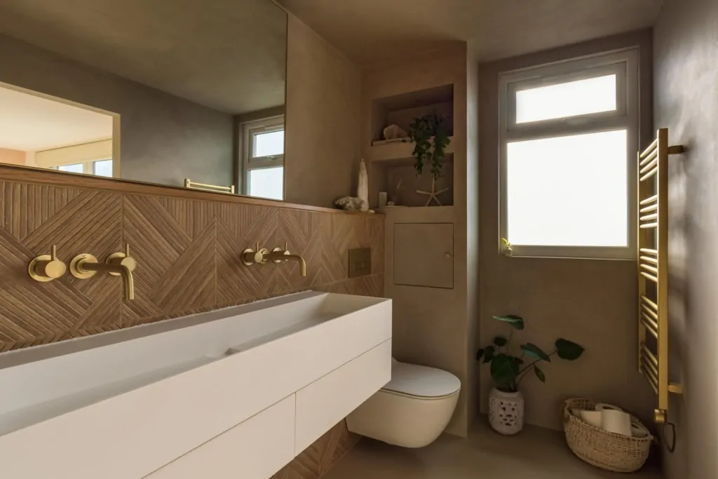 Warm neutral bathroom vanity with integrated basin and bespoke storage