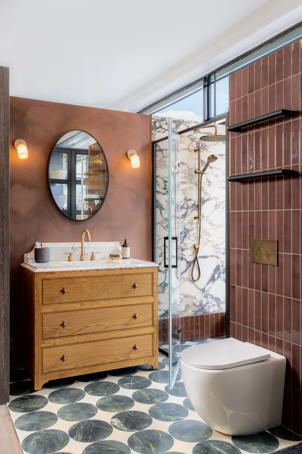 Luxury bathroom showroom display featuring warm-toned tiles, vanity unit and designer bathroom fittings