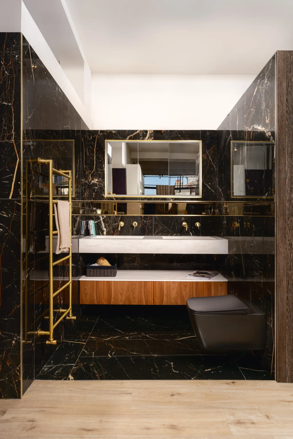 Luxury bathroom showroom display featuring a dark contemporary bathroom design with marble finishes