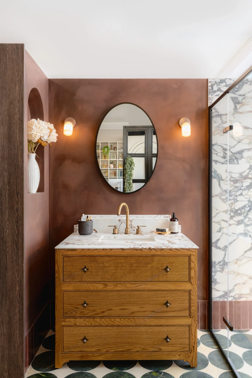 Contemporary bathroom showroom display with textured wall tiles, vanity unit and modern lighting