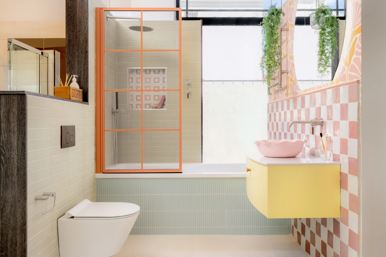 Luxury bathroom showroom display featuring a glass shower enclosure, freestanding bath and neutral finishes