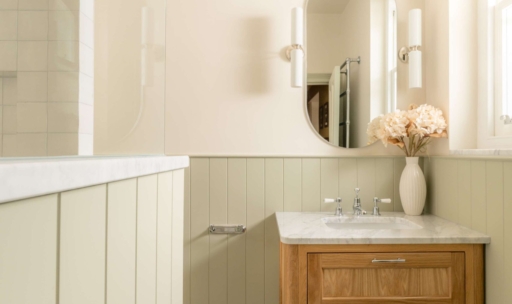 Hampton family bathroom in Hove with an oak vanity, marble worktop, sage panelling and Ca' Pietra basketweave mosaic floor.